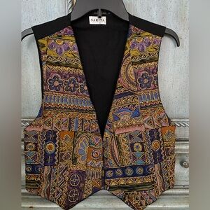 Vest with gold beading outlining fabric patterns (flowers, boxes, circles, etc)